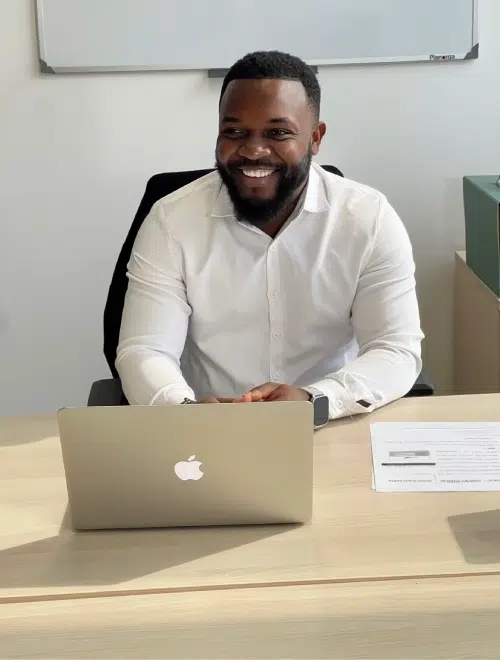 Homme souriant devant un ordinateur portable